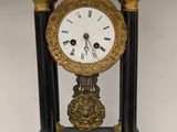 a black and gold clock sitting on top of a table