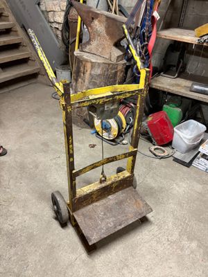 a hand truck with a large piece of wood on it