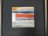 tableau abstrait aux couleurs orange, blanc et bleu, dans un cadre noir