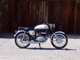 a motorcycle that is parked in front of a wooden fence
