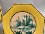 three yellow plates with a picture of a castle on them