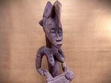 statue of a woman holding a piece of wood in her right hand