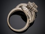 a close up of a diamond ring on a black surface