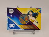 a close up of a coin on a stand with a picture of wonder woman