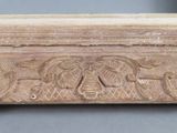 an image of a close up of a wooden frame with carvings on it