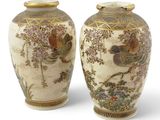 pair of asian vases decorated with birds and flowers on a white background