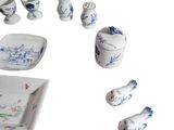 a white plate with blue and white dishes and cups on it