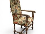 an old wooden chair with a floral upholstered seat