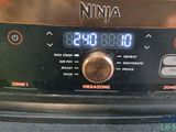 a close up of a digital clock on the side of a stove