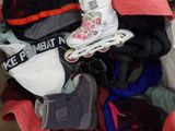 a box full of clothes and shoes that are packed together