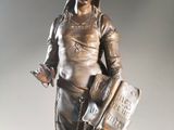 a statue of a woman holding a book and a book