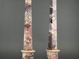 a pair of pink marble obelisks on marble bases