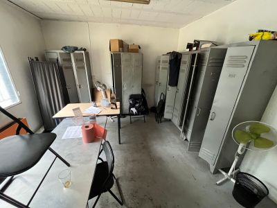 many lockers in a room with a table and chairs