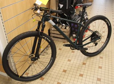 a bike that is parked in a store with a backpack on the back