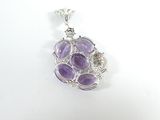 a close up of a purple stone pendant on a white surface