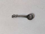 a close up of a small metal object on a white surface