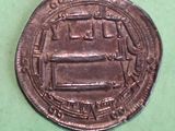 an old coin that is on a green surface