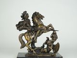 une statue en bronze représentant un homme à cheval accompagné d'un chien