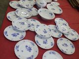 many plates on a table with a red table cloth