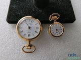 a small gold pocket watch and a small gold pocket watch