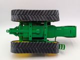 a toy tractor that is sitting on a white surface