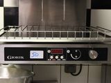 an image of a commercial kitchen with a stove and a pot
