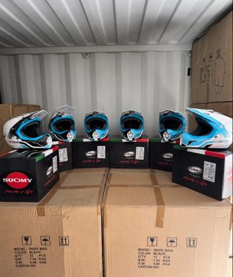 boxes of helmets are stacked on top of each other in a shipping container