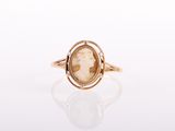 a gold ring with a picture of a woman in profile