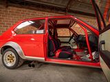 a red car with its door open in a garage