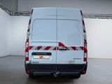 the rear end of a white van with a red and white stripe on it