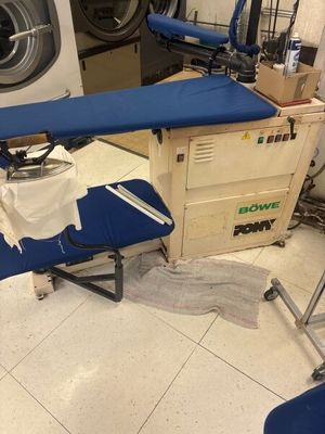 a blue ironing board sitting on top of a blue ironing board