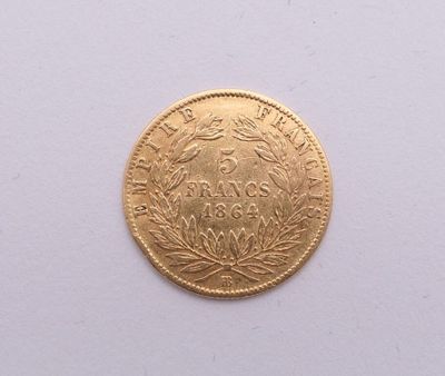 gros plan d'une pièce d'or sur une surface blanche