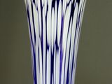 a blue and white vase that is sitting on a table