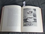 an open book with a picture of a little girl in a dress