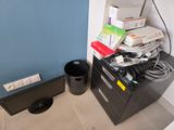 a trash can sitting next to a filing cabinet in a room