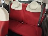 two seats in the back of a car that are red and white