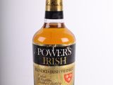 a bottle of whisky sitting on top of a white table