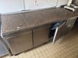 a kitchen with a counter and a refrigerator in it