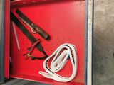 a red box with tools inside of it on the floor