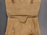 the inside of a tan canvas briefcase with a leather handle