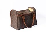 a brown and brown bag with a handle on a white background