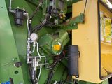 a large green machine that is parked in a lot