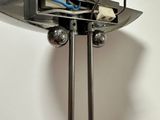 a metal stand with a mirror and a pair of scissors on it