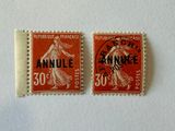 two stamps with the words annule and 50 cents are on a white surface