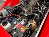 a red car with an engine in it ' s trunk