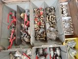 many different types of pipes and fittings in a box