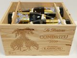bottles of wine are in a wooden box on a table