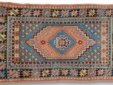 a blue and orange rug with a diamond design