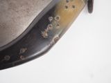 a close up of a knife with holes on it