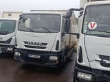 three trucks that are parked next to each other in a parking lot